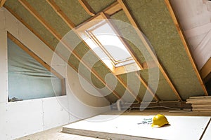 House attic under construction mansard wall insulation with rock