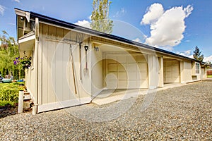 House backyard. View of garage and driveway