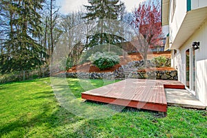 House backyard view. Wooden floor walkout deck