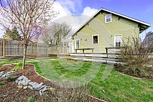 House backyard with walkout deck and small garden