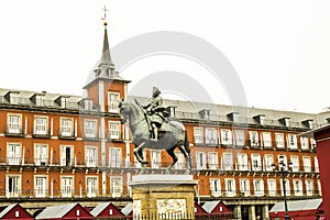 Equestrian statue of Felipe III House of the Bakery in the background in . Madrid photo