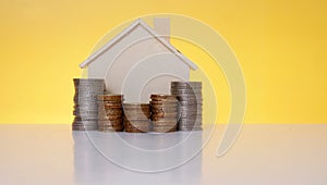 House bank on stacked coins - Conceptual image