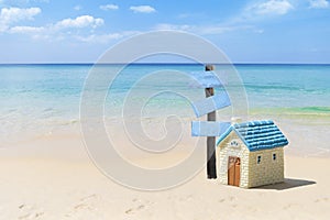 House on the beach with wooden sign, beach hosue for sale