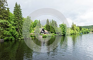 House behind forest nearby lake at Titisee-Neustadt, Germany.