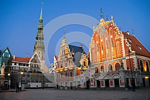 Riga, Latvia. House of the Blackheads building, Melngalvju nams, with view on tower of St. Peter Church in Riga.