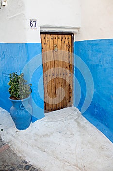 House with blue walls and wooden door