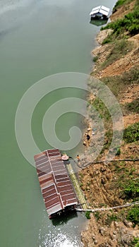 House boat floating in quiet Chongalia River