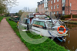 a house bot moored on a canal towpath photo