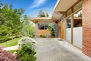 House with brick trim. Entrance porch and front yard view