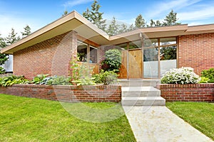 House with brick trim. Entrance porch and front yard view