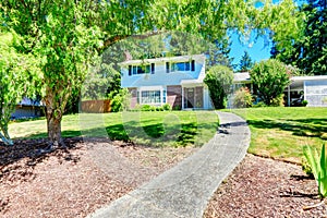 House with brick wall trim. View of entrance porch and walkway