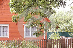 House bright stands in the woods on a Sunny autumn day