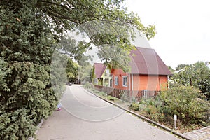 House bright stands in the woods on a Sunny autumn day