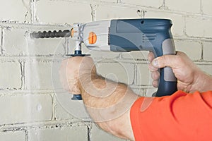 House-builder working with a perforator