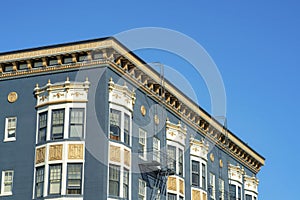 House or building facade in the downtown city neighborhoods with blue stucco and white accent exterior with flat roof