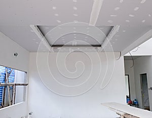 house building interier install ceiling wall with white cement plaster smooth surface. inside room structure painter by craftsman.