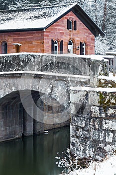 House by canal-bridge winter scene