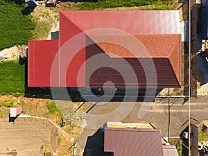 A house with a canopy over the courtyard. Roof from corrugated metal profile. Metal tiles.