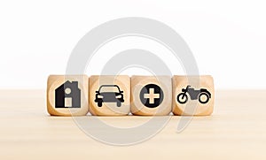 House, car, health and bike icons on wooden blocks Types of insurance concept