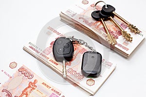 House and car keys on money