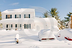 House and cars after snowstorm