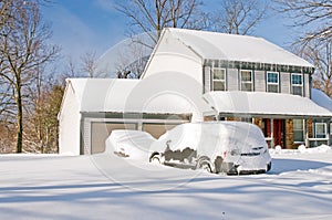 House and cars after snowstorm