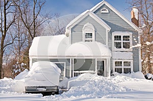 House and cars after snowstorm