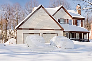 House and cars after snowstorm