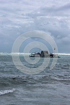 A house for catching bilis, squid, fish ponds called `kelong` in Bintan, Indonesia with storm and hurricane