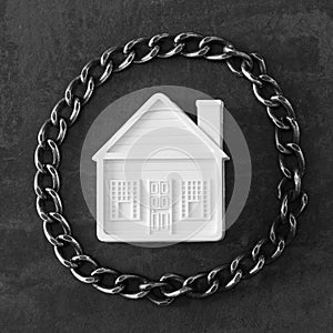 House in chains. Concept - risks, lose property, seize, mortgage