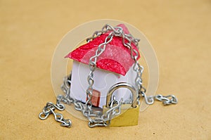 House in chains locked with padlock, mortgage and foreclosure concept