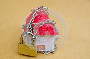 House in chains locked with padlock, mortgage and foreclosure concept