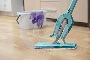 house cleaning - mop washing wooden floor. Wet cleaning concept background.