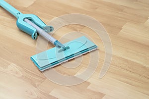 house cleaning - mop washing wooden floor. Wet cleaning concept background.