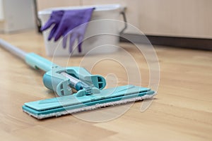 house cleaning - mop washing wooden floor. Wet cleaning concept background.