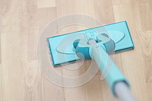 house cleaning - mop washing wooden floor. Wet cleaning concept background.