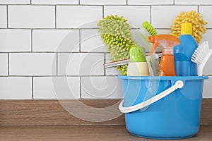 House cleaning plastic product on wood table with white brick background, home service or housekeeping concept