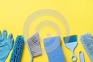 House cleaning product equipment on yellow table background