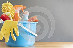 House cleaning product on wood table with gray background, home service or housekeeping concept