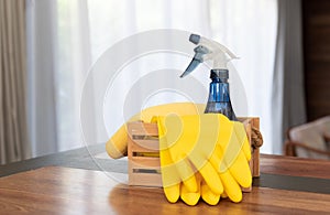 House cleaning products set on wooden table in living room