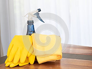 House cleaning products set on wooden table in living room