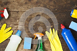 House cleaning products variety on wooden background, top view. From above, flat lay.