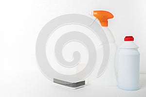 House cleaning. Sponges and means for cleaning plumbing, sinks, bathtubs, toilet bowls in bottles on a white background with