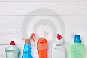 House cleaning supplies on wooden background.