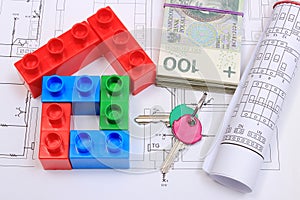 House of colorful building blocks, keys, banknotes and drawings