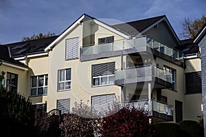 House with condominiums on a slope under a blue sky