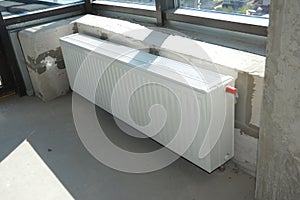 House construction heating system and radiator heating. Installing radiator heating at home.  White metal radiators heating photo