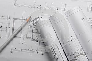 House construction plans and a pencil. Wrapped in a roll. Text space photo