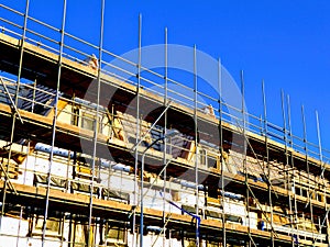 House construction, scaffolding on building project. Civilian home building.