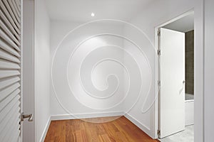 House corridor with white walls and wooden floor